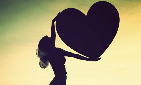 silhouette-of-woman-holding-big-heart