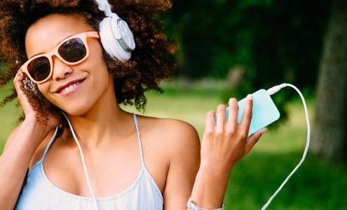 woman with headphones summer playlist