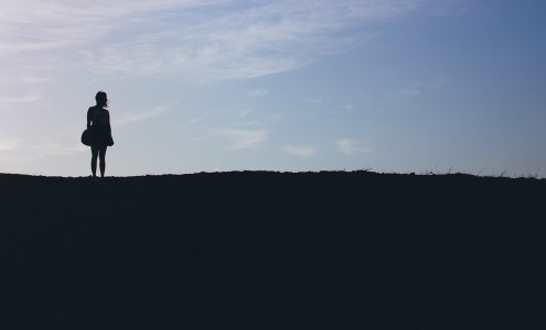 Girl Standing on Hill