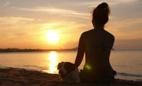 Woman Meditating on Beach