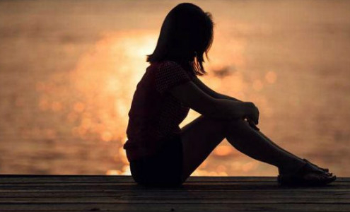 Girl Sitting On Beach