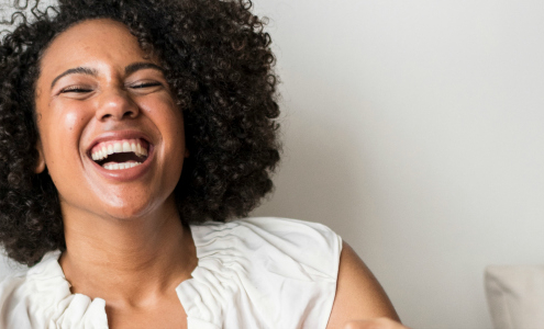 Canva - Smiling Woman Sitting on the Bed (banner)